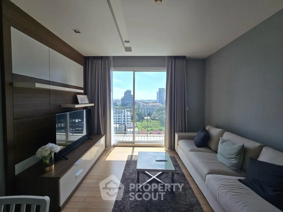 Modern living room with large window offering stunning city view