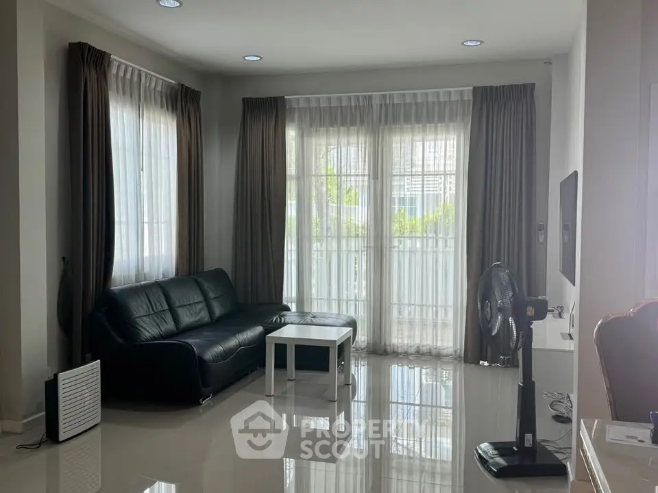 Spacious living room with modern decor and natural light