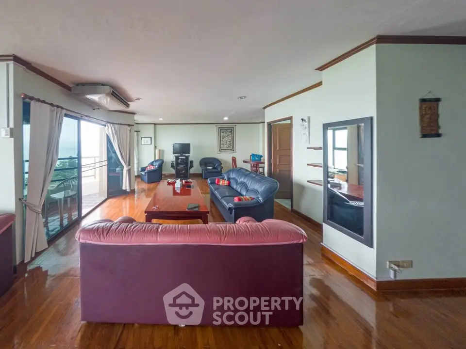 Spacious living room with elegant furniture and stunning balcony view