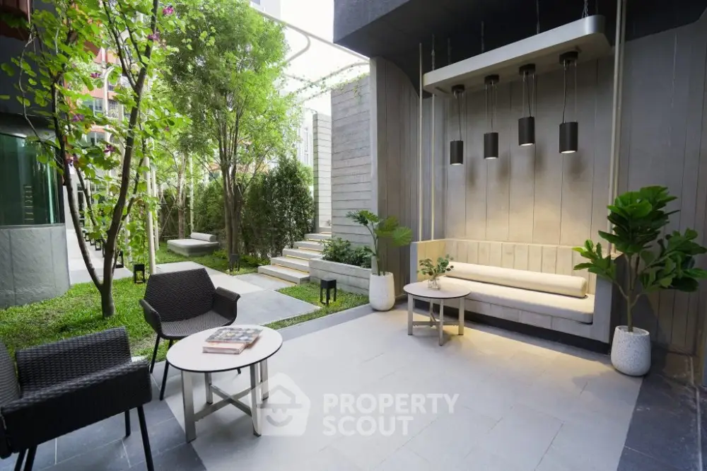 Modern garden patio with stylish seating and lush greenery