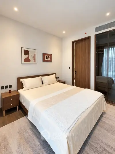 Modern bedroom with stylish decor and cozy ambiance, featuring a comfortable bed and elegant furnishings.