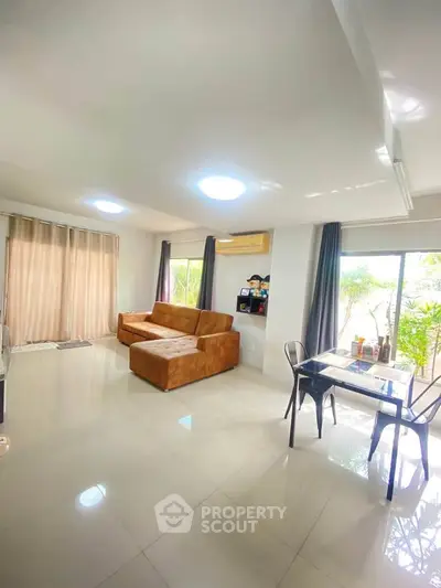 Spacious living room with modern furniture and large windows for natural light.