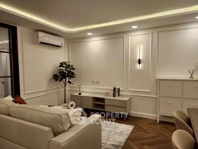 Elegant living room with modern decor and ambient lighting, featuring a cozy sofa and stylish storage solutions.