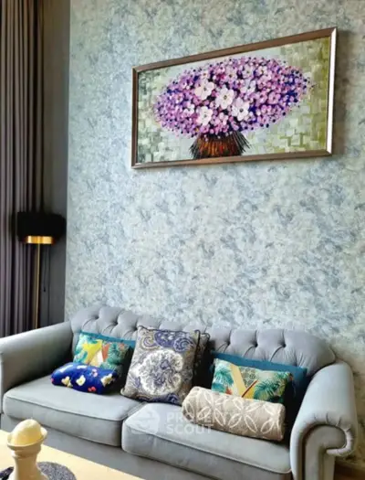 Elegant living room with plush sofa, vibrant cushions, and floral artwork, perfect for modern home decor.