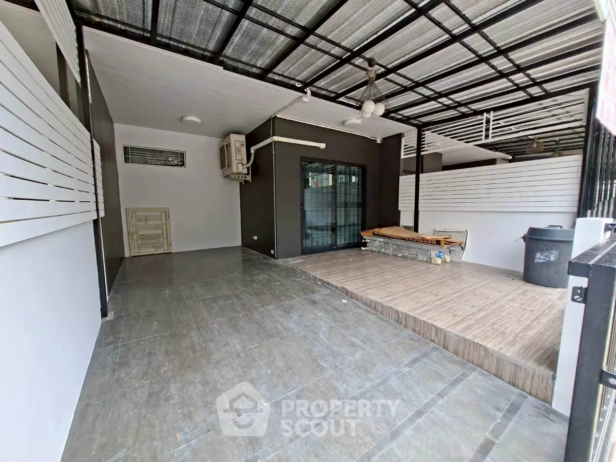 Spacious covered outdoor area with modern design and tiled flooring