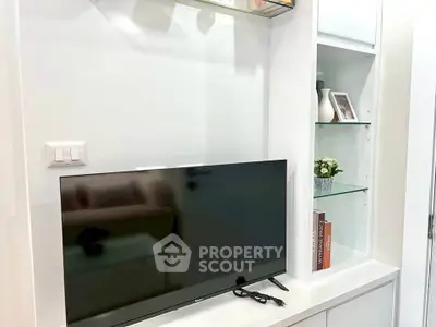 Modern living room with sleek TV setup and stylish shelving unit