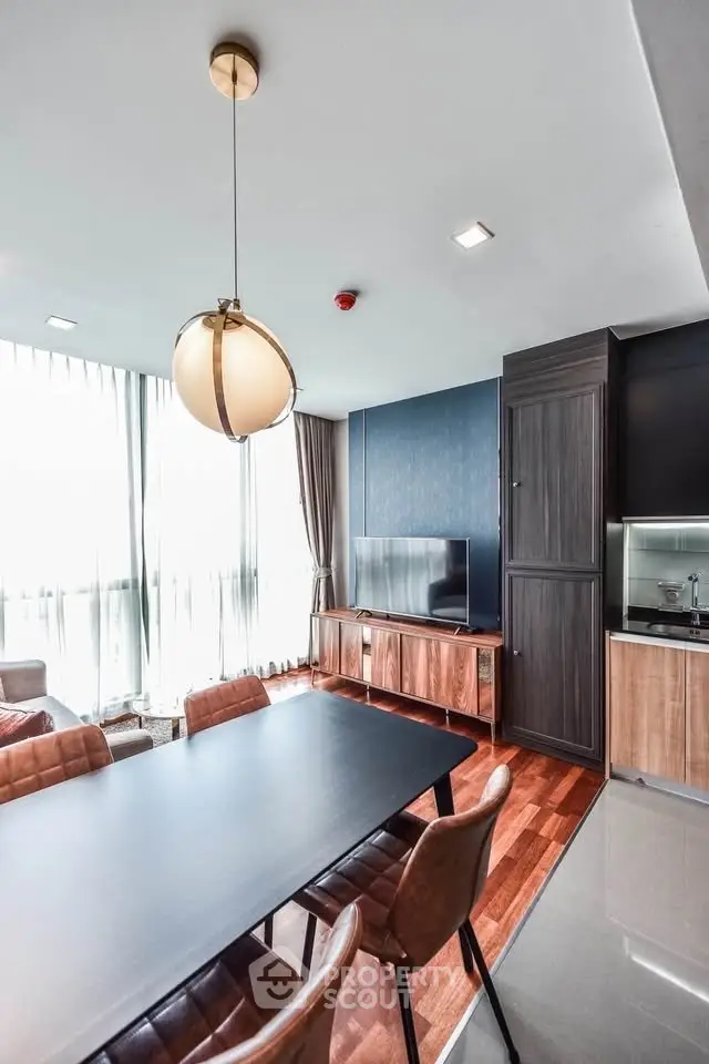 Modern living room with elegant dining area and stylish decor in a luxury apartment.