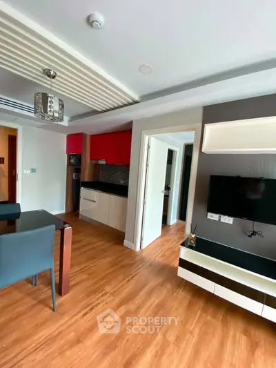 Modern open-plan living room with stylish kitchen and wooden flooring