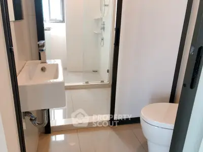Modern bathroom with sleek fixtures and glass shower enclosure