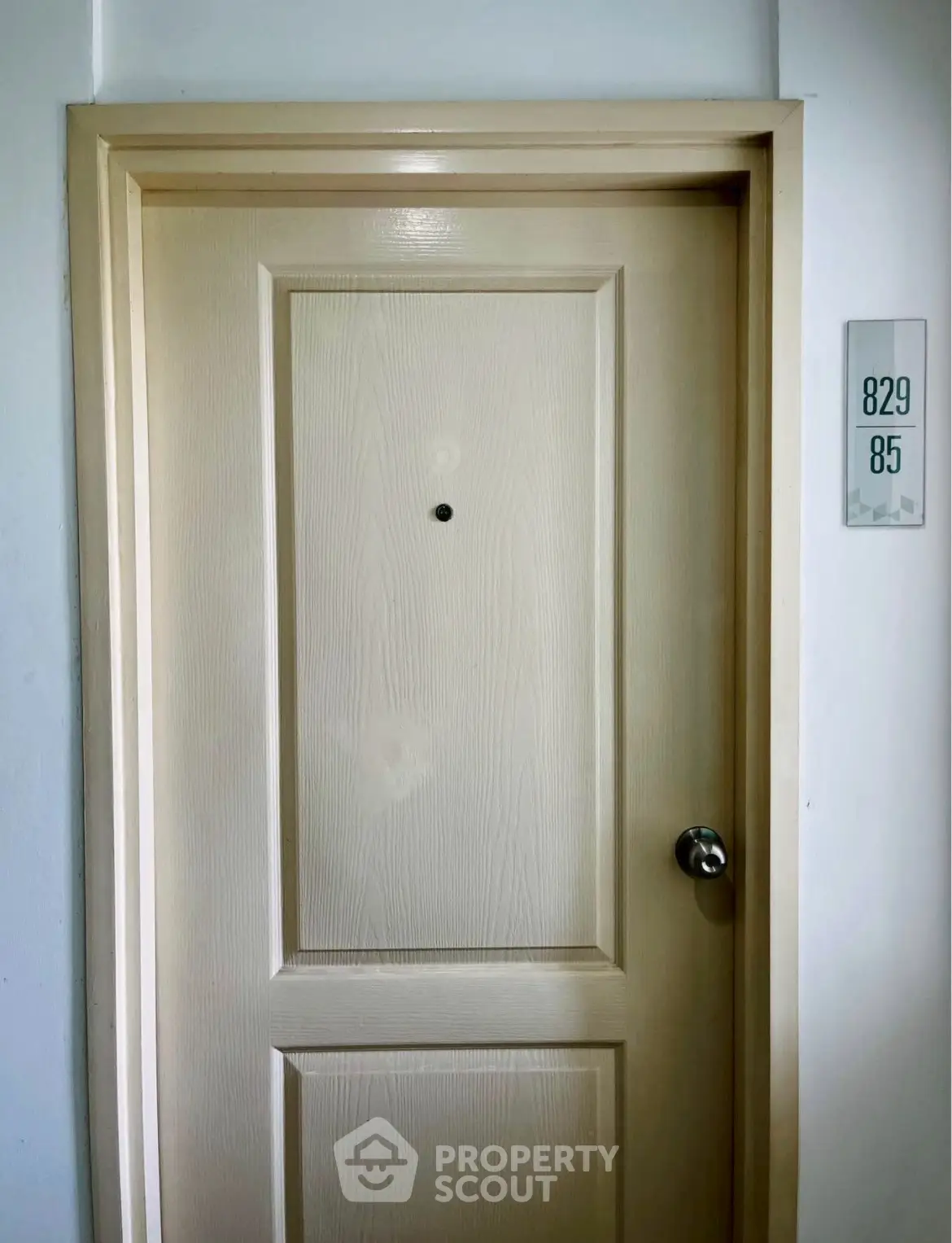 Elegant apartment entrance door with unit number, showcasing a modern and secure entryway.