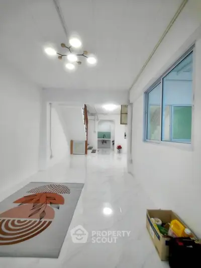 Spacious modern hallway with marble flooring and stylish lighting