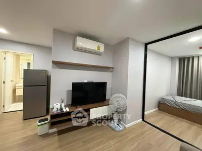 Modern apartment interior with living room and bedroom, featuring sleek design and contemporary furnishings.