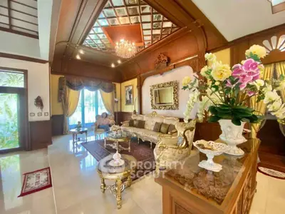 Luxurious living room with elegant decor and chandelier in a spacious home.