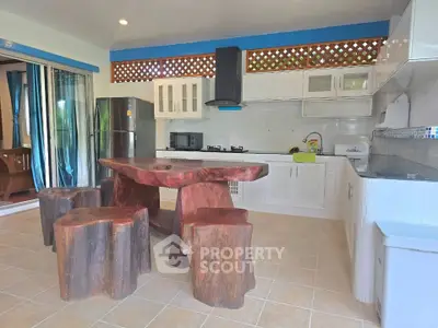 Spacious kitchen with unique wooden dining set and modern appliances