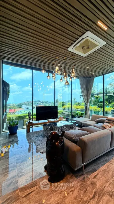 Luxurious living room with panoramic views and modern decor, featuring a stylish chandelier and plush seating.
