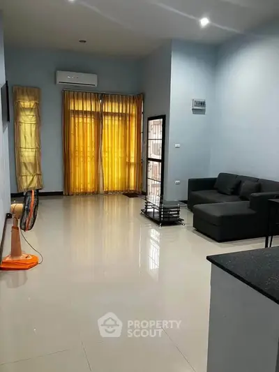 Spacious living room with modern sofa and large windows for natural light