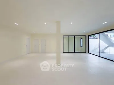 Spacious modern living room with large windows and minimalist design