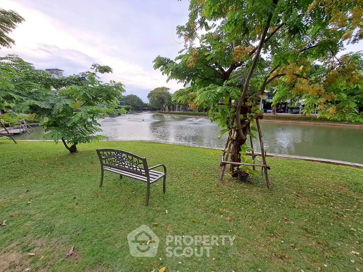Serene garden view with a tranquil pond and lush greenery, perfect for relaxation and outdoor enjoyment.