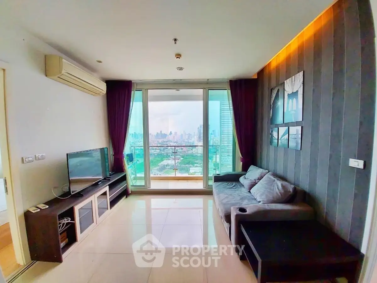 Modern living room with city view, featuring sleek furniture and large windows for natural light.