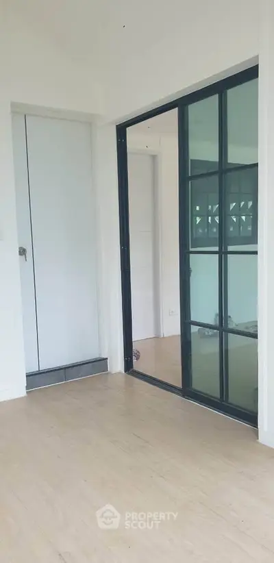 Modern interior with sliding glass door and wooden flooring