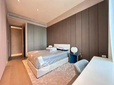 Luxurious modern bedroom with elegant wood paneling and plush carpeting, featuring a cozy bed and stylish decor.