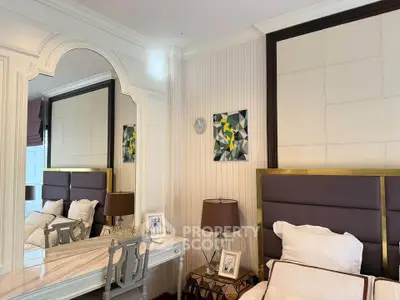 Elegant bedroom with stylish decor, featuring a luxurious headboard and a chic vanity mirror.
