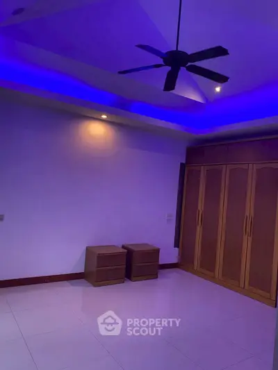 Spacious bedroom with modern lighting and ceiling fan