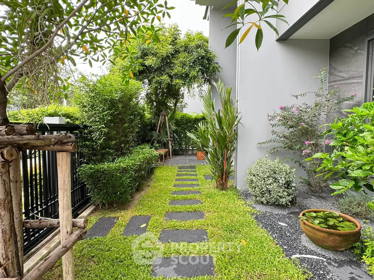 Charming garden pathway with lush greenery and modern exterior design, perfect for relaxation and outdoor enjoyment.
