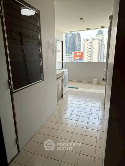 Urban apartment balcony with city view and washing machine