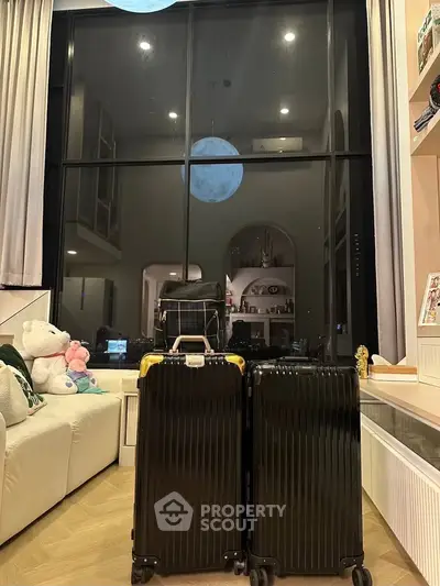 Spacious living room with large window and cozy seating area