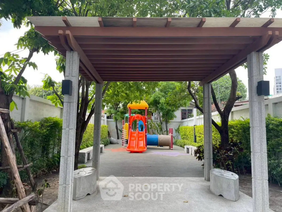 Charming outdoor playground in lush garden setting, perfect for family-friendly living.