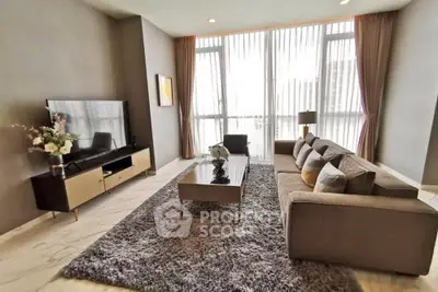 Spacious modern living room with large windows and elegant decor