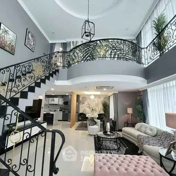 Luxurious open-plan living room with elegant staircase and modern decor