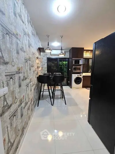 Modern kitchen with stylish wallpaper and sleek appliances, featuring a cozy dining area.