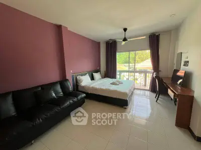 Spacious bedroom with balcony access and modern furnishings