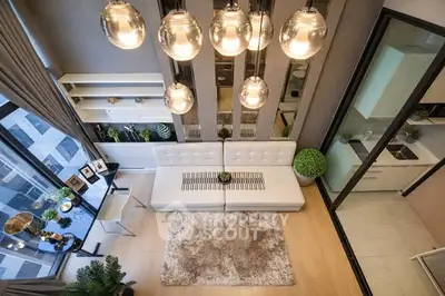 Luxurious modern living room with high ceilings and elegant lighting in a stylish apartment.