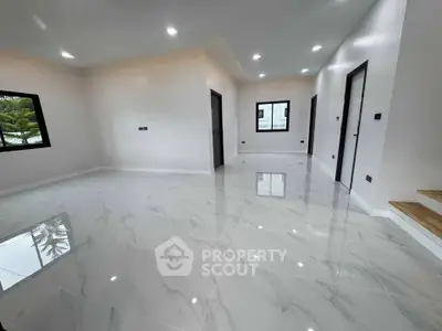 Spacious modern living room with glossy marble flooring and recessed lighting