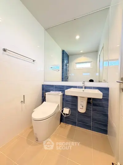 Modern bathroom with sleek design and blue accent tiles