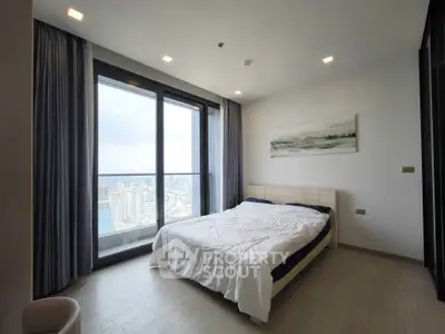Spacious bedroom with stunning city view and modern decor
