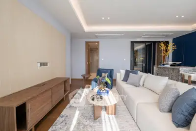 Modern living room with stylish furniture and elegant decor, featuring a cozy seating area and contemporary design.