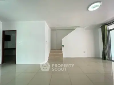 Spacious modern living room with sleek tile flooring and natural light