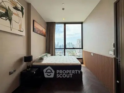 Modern bedroom with city view, featuring stylish decor and large window for natural light.