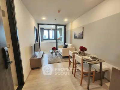 Modern living room with dining area and large windows in a stylish apartment.
