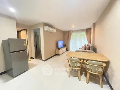 Modern living room with dining area and sleek furniture in a cozy apartment.