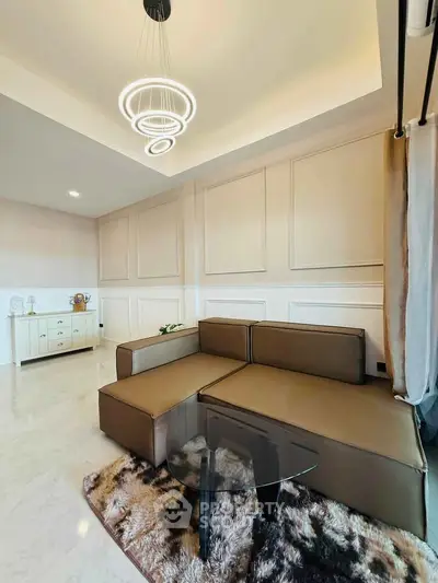 Modern living room with stylish sectional sofa and elegant lighting fixture