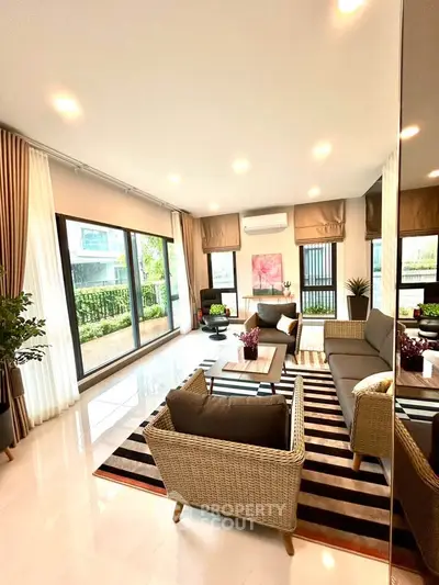 Spacious modern living room with large windows and stylish decor in a luxury apartment.
