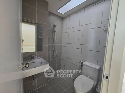 Modern bathroom with sleek gray tiles and contemporary fixtures