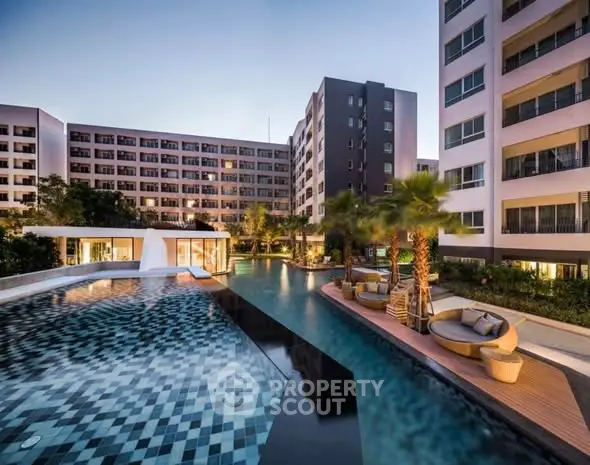 Luxurious apartment complex with stunning pool and modern architecture.