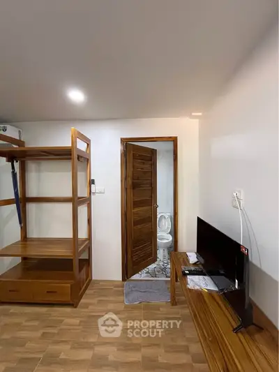 Cozy bedroom with wooden furniture and ensuite bathroom