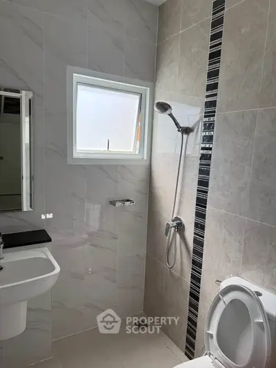 Modern bathroom with sleek shower and elegant tile design, perfect for a contemporary home.